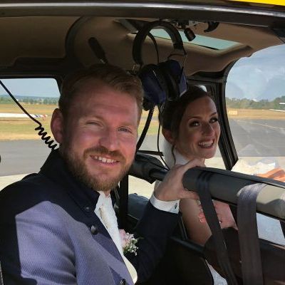 A bride and groom in a helicopter