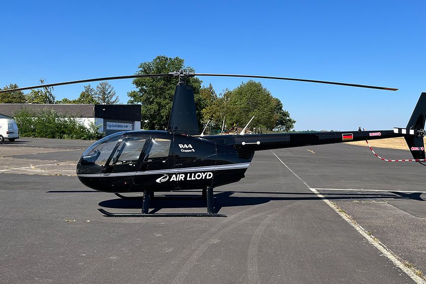 A black Air Lloyd helicopter on the landing pad