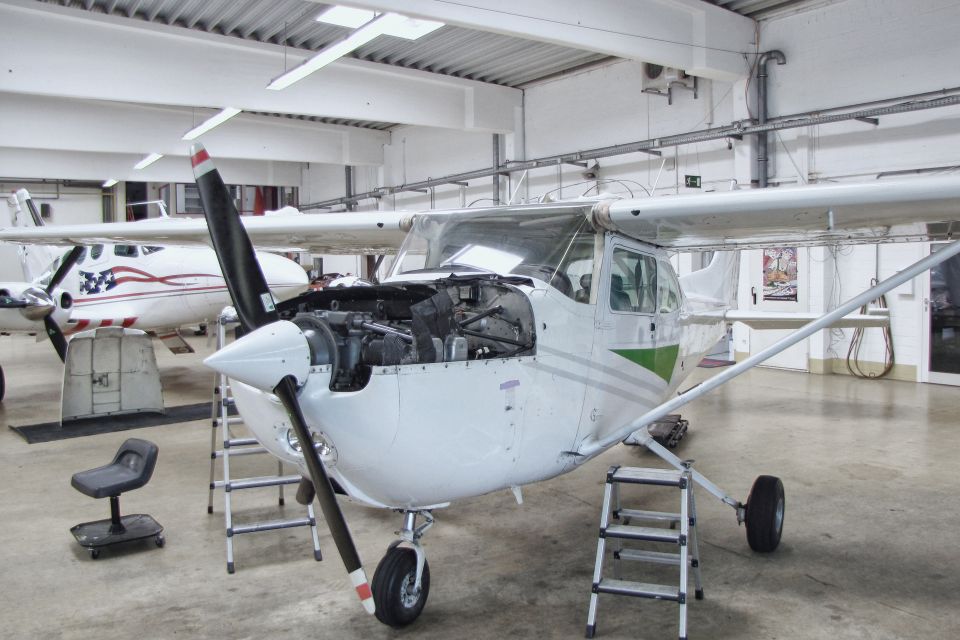 A small white airplane in the hangar.