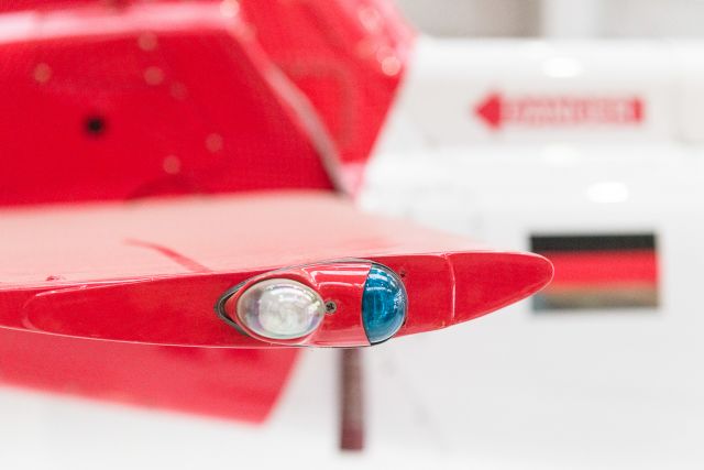A close-up of a red helicopter with a light on it.