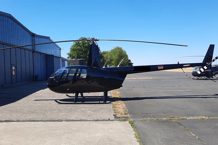 Ein schwarzer Air Lloyd Helikopter auf dem Landeplatz