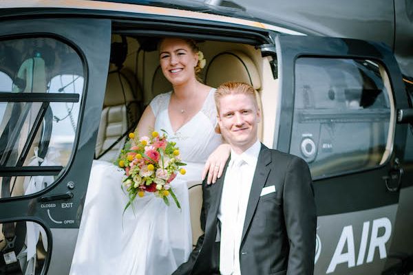 A bride and groom in a black helicopter